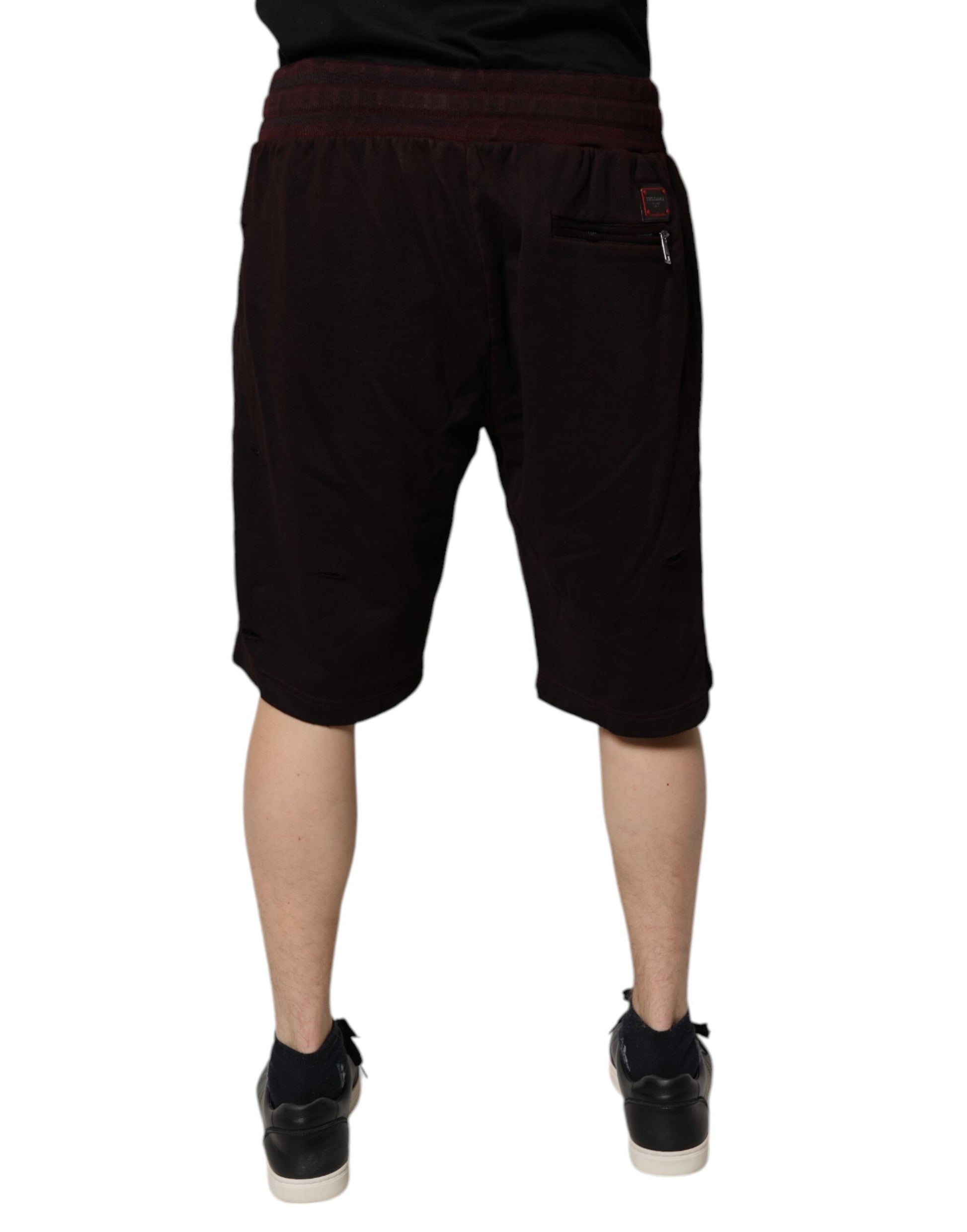A pair of black shorts with a red stripe on the side. They are designed for active wear and feature a drawstr