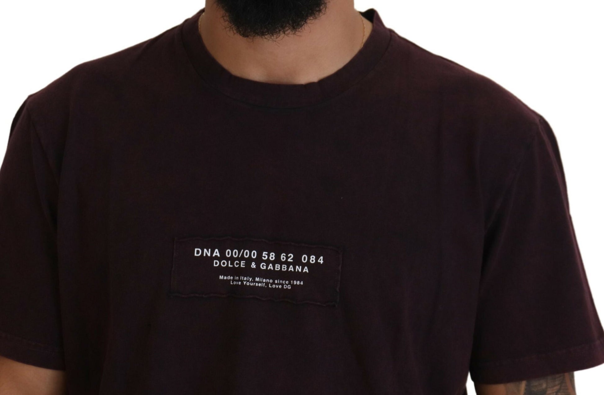 Mannequin torso wearing dark t-shirt with white text on front pocket