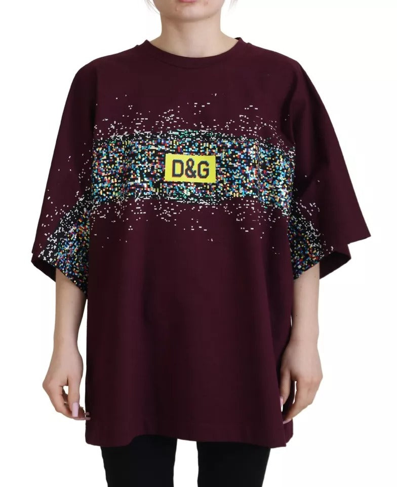 Woman wearing maroon shirt with yellow tag on front