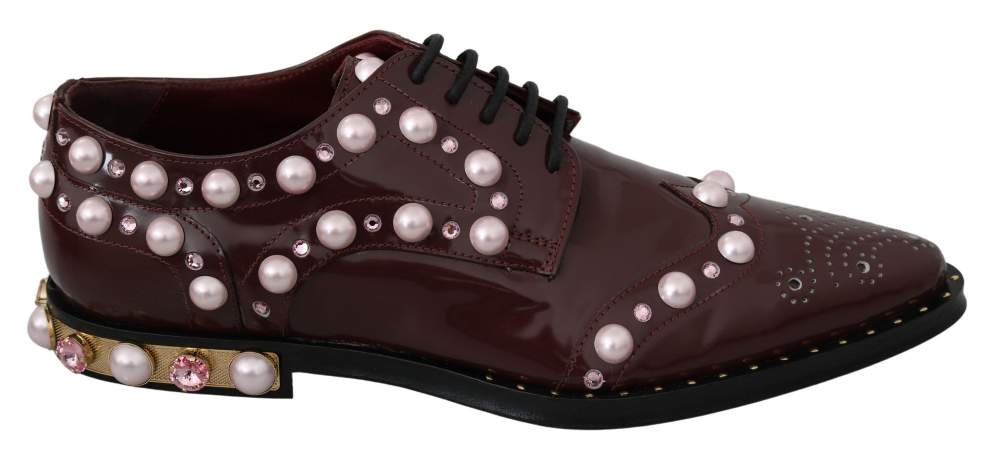 Pair of women's shoes with pearl embellishments and gold accents