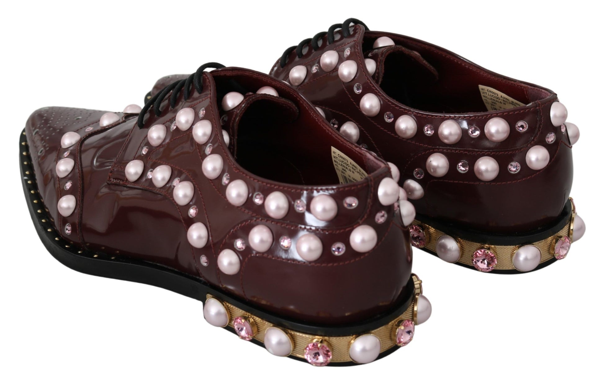 Pair of brown shoes with pearl embellishments and gold accents
