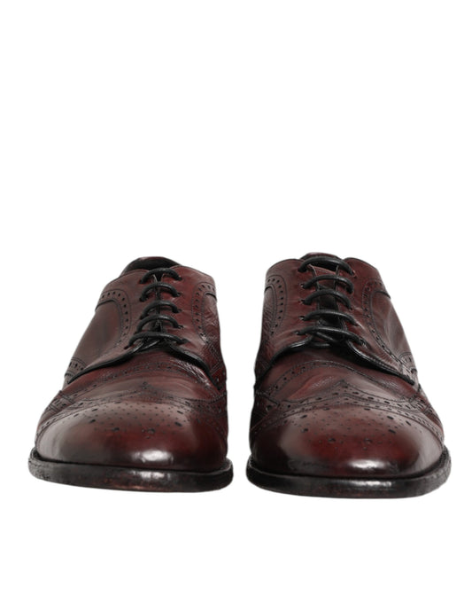 Pair of brown leather lace-up dress shoes with black laces and soles