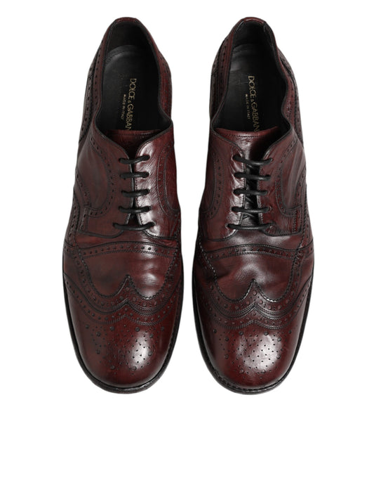Pair of red leather lace-up dress shoes with a bird design on the side