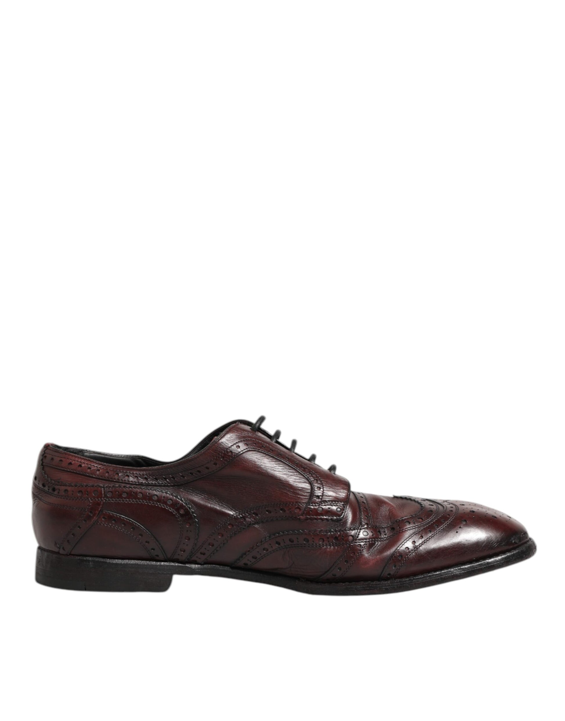 A pair of red leather lace-up dress shoes with a bow tie design