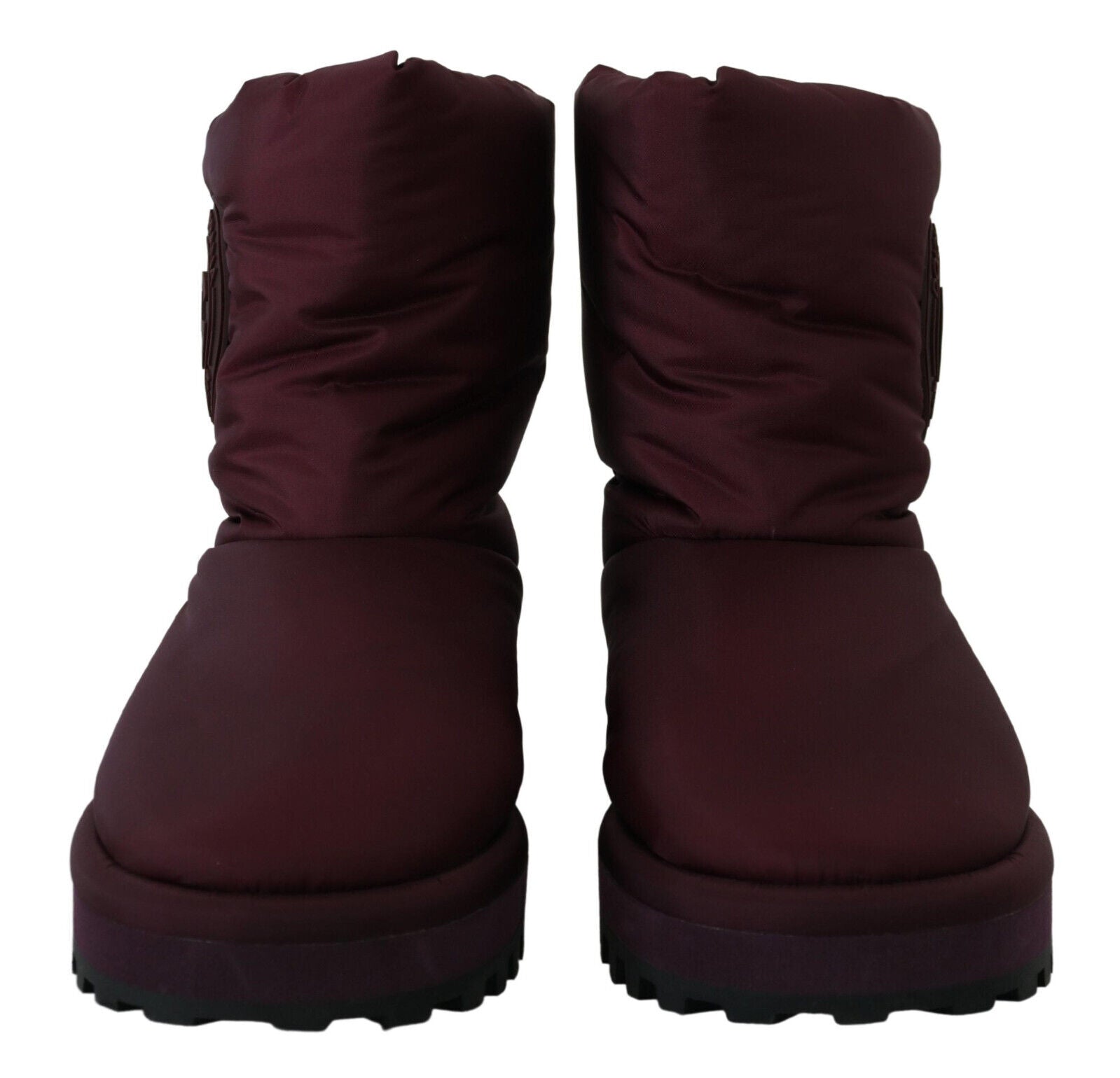 Pair of dark purple winter boots with laces and a pull tab on top