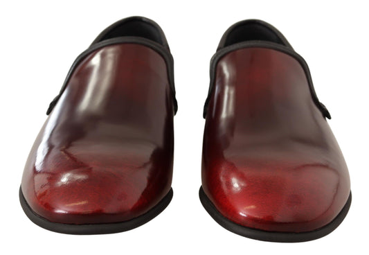 Pair of red leather shoes with black soles and laces