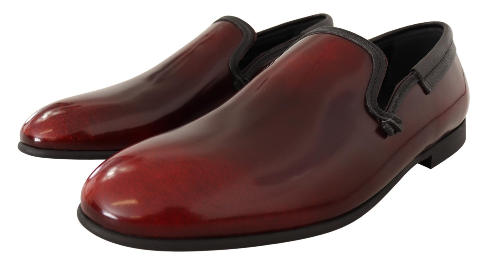 Pair of red leather shoes with black laces and soles