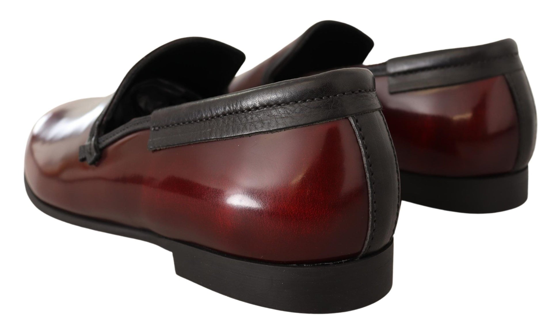 Pair of black dress shoes with red patent leather toe and heel