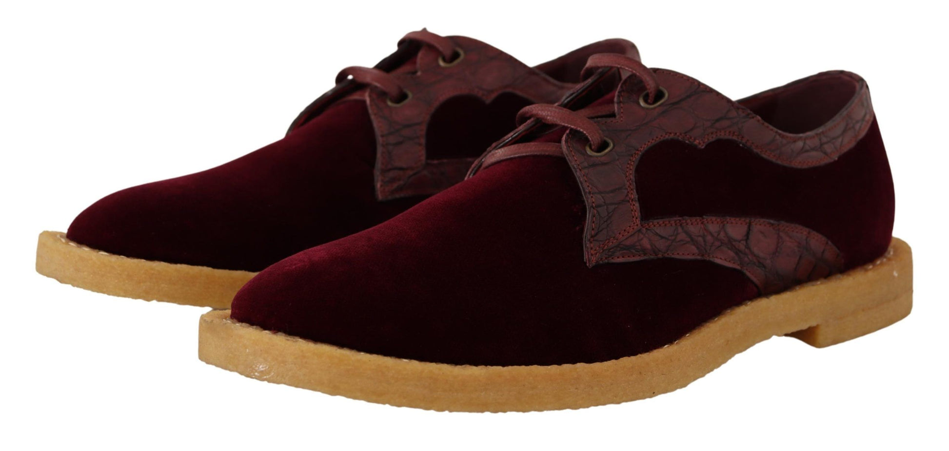 Pair of burgundy velvet shoes with tan soles and laces