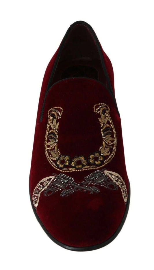 Red velvet slippers with gold embroidery and a horse shoe design on top