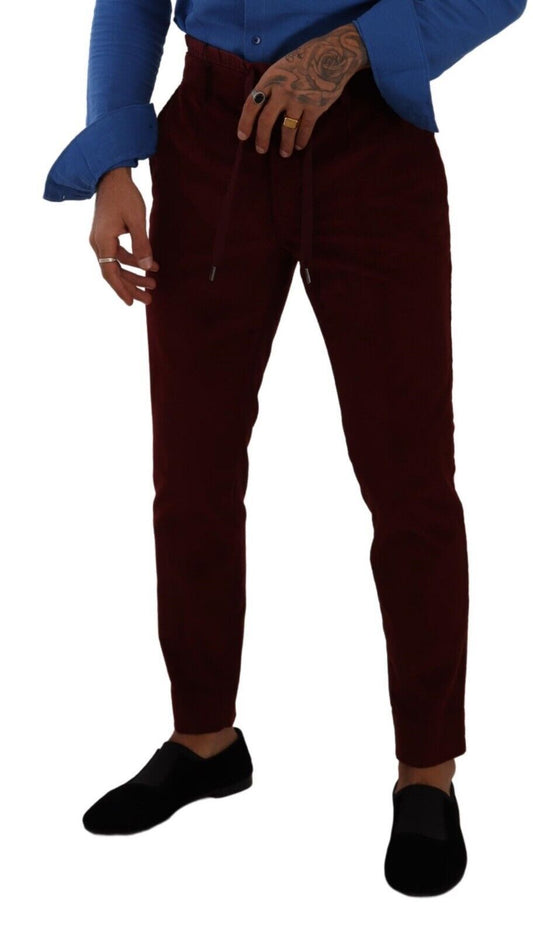 Pair of burgundy trousers with a blue shirt and black shoes