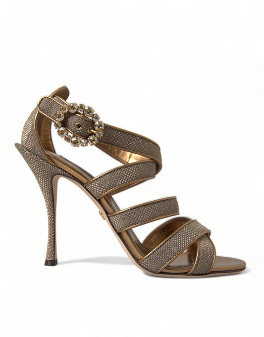 Gold strappy high heel sandals with rhinestone embellishments on top of foot and ankle strap
