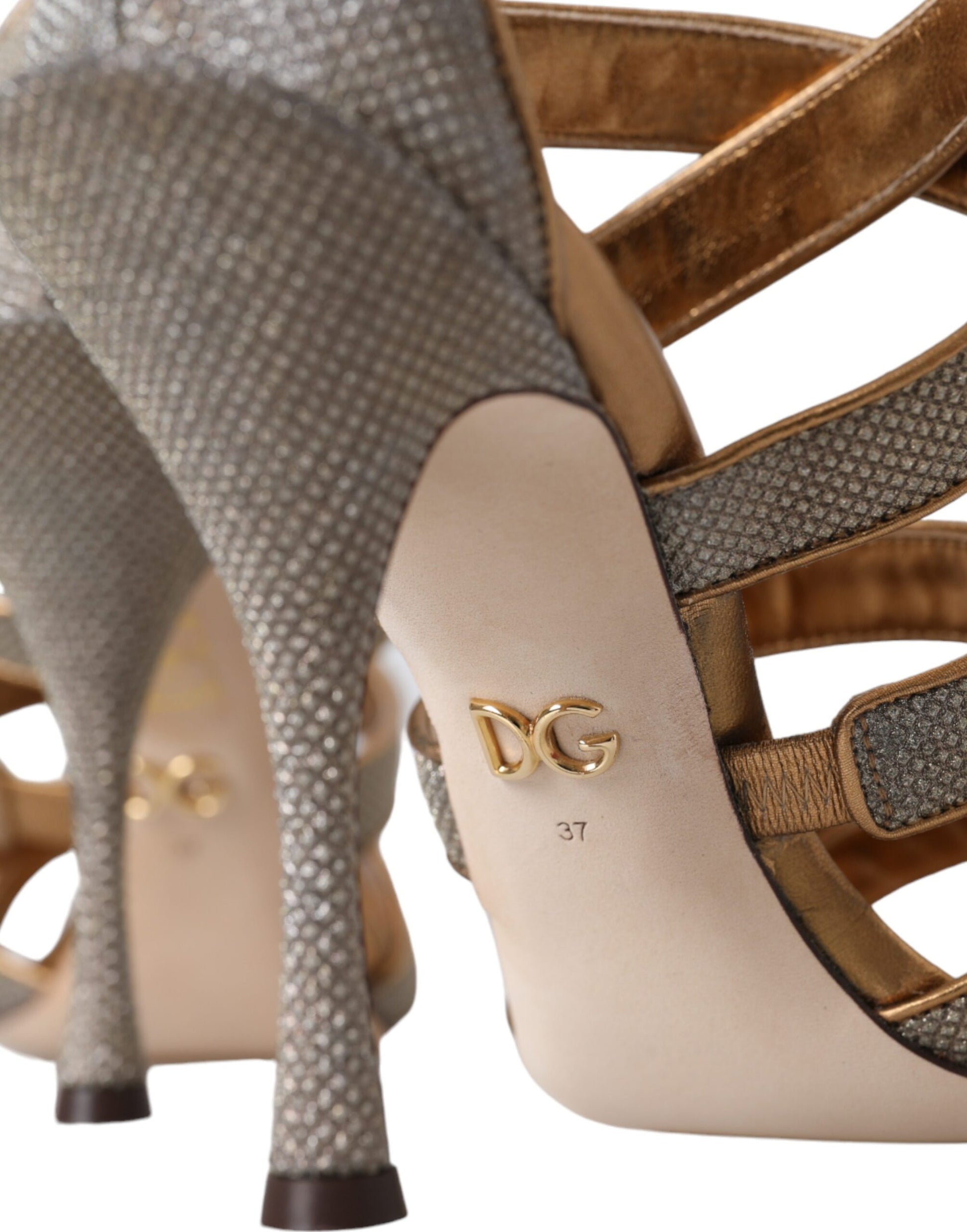 High heel shoes with gold accents and a logo on the insole