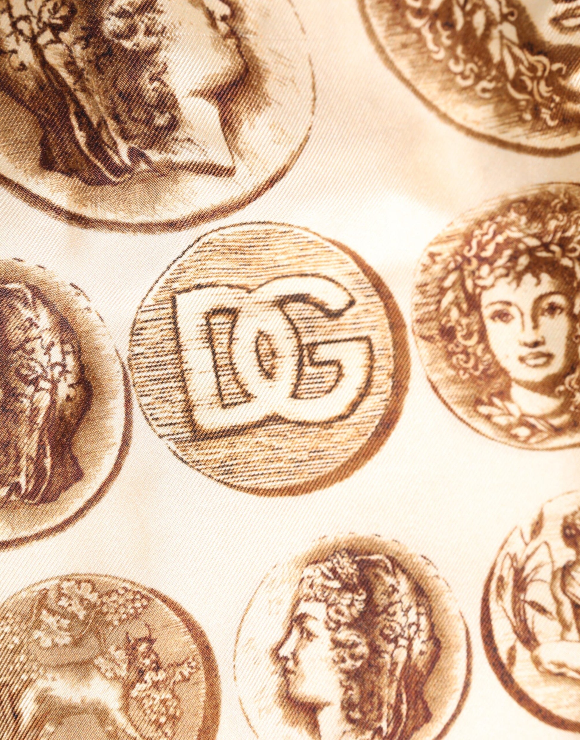 A pair of brown ancient coin print silk shorts from the Dolce & Gabbana brand