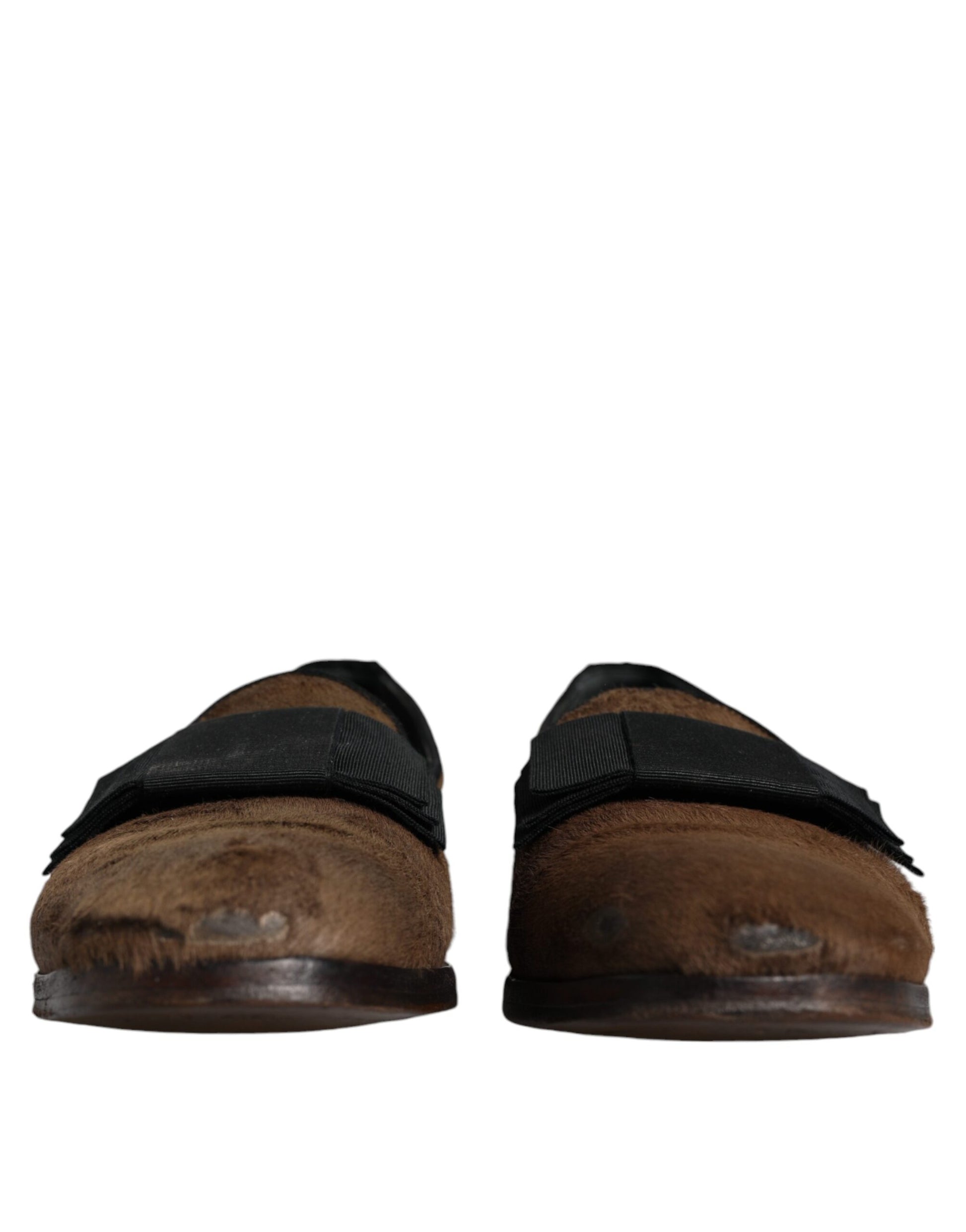 Pair of brown leather loafers with black straps, featuring calf hair detailing