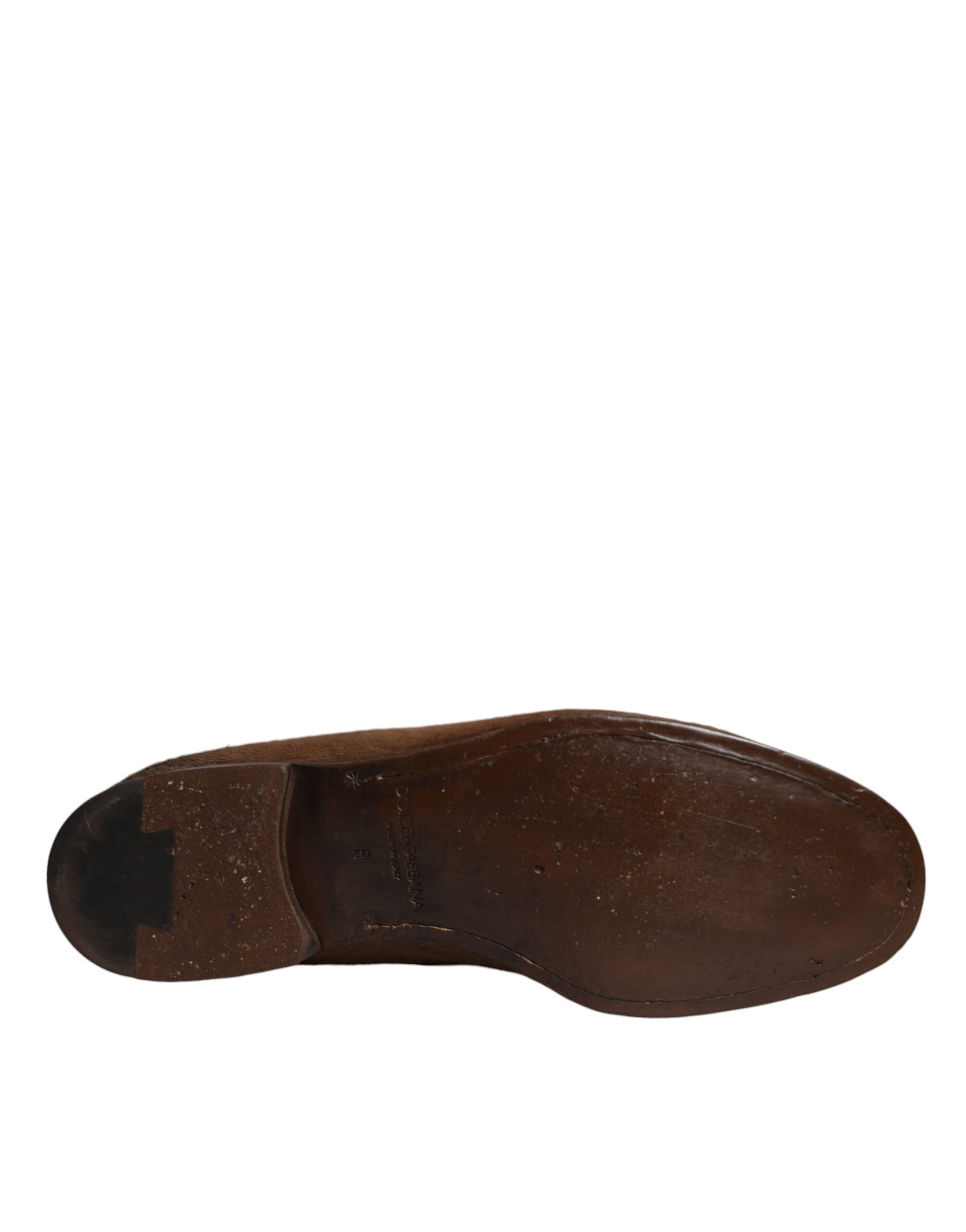 A single brown leather loafer shoe with a visible stitch pattern