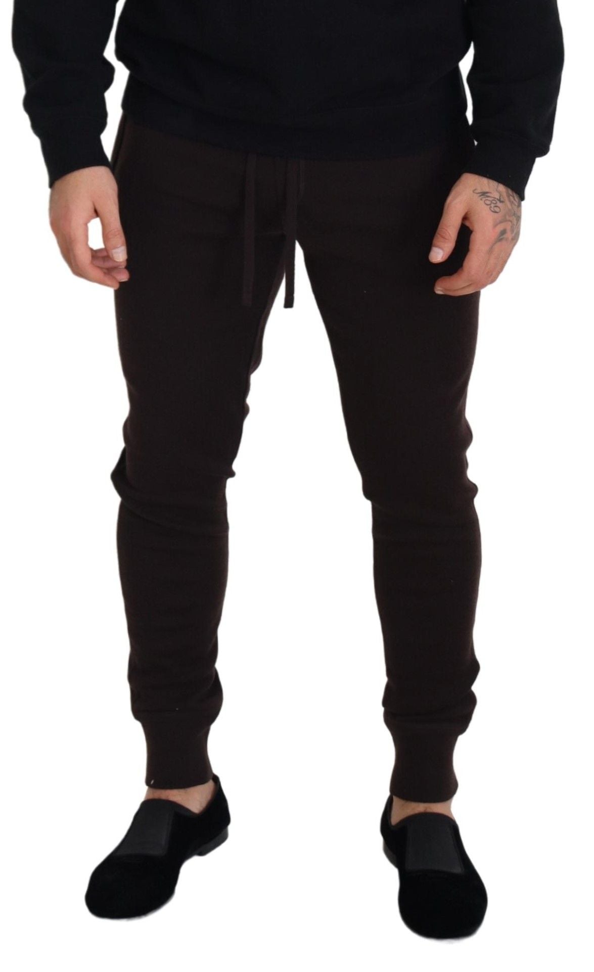 Man wearing brown sweatpants and black shoes