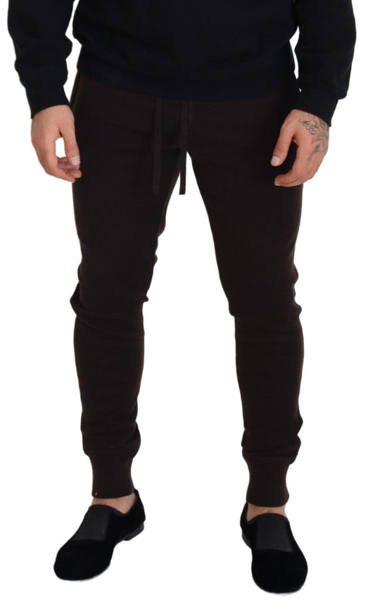 Man wearing brown sweatpants and black shoes