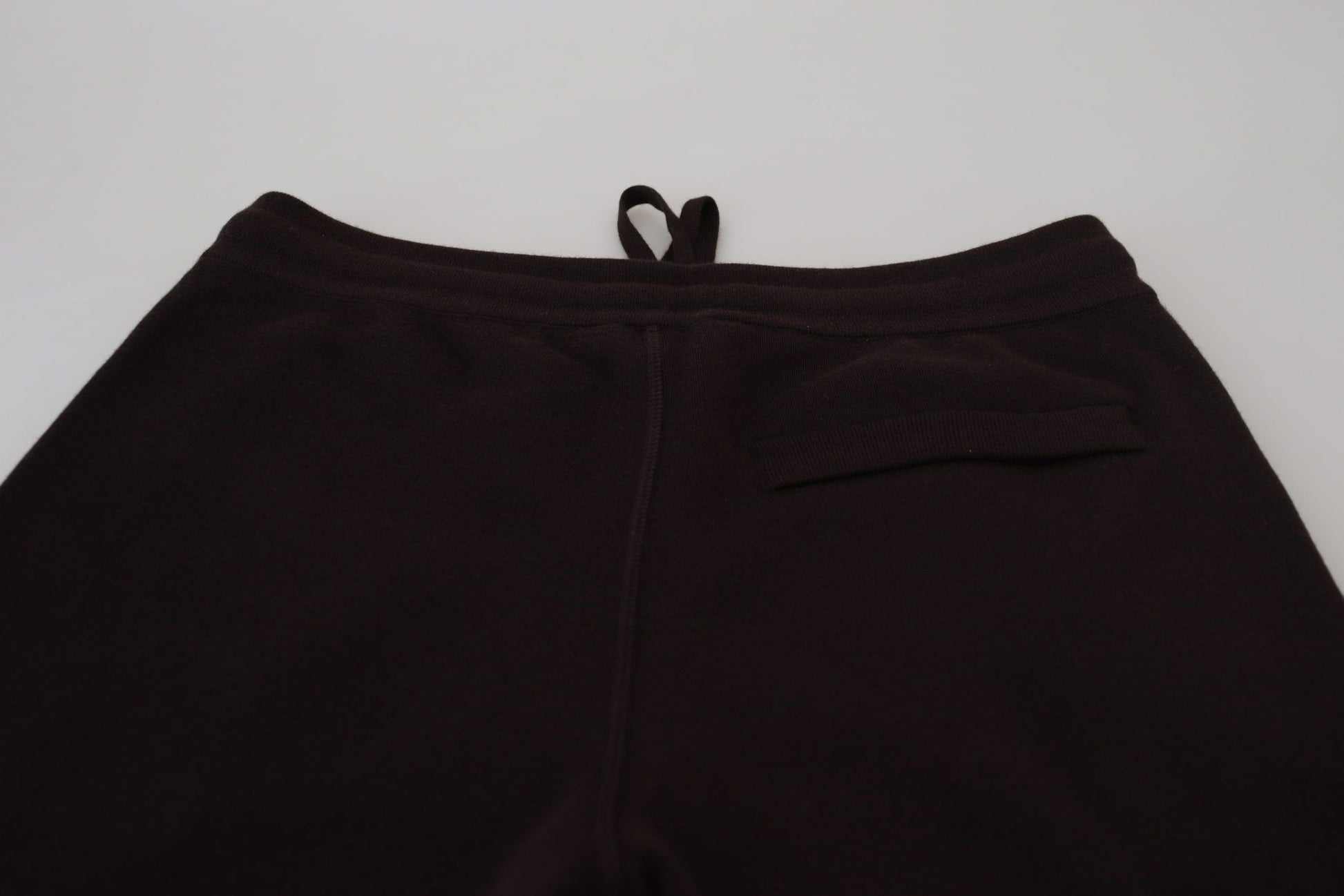 Black sweatpants on a white surface