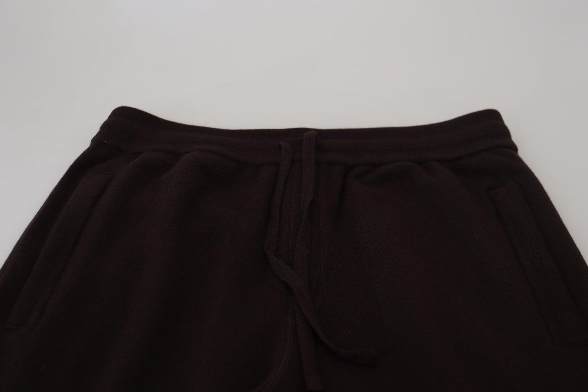 Black sweatpants on a white surface