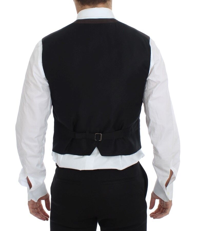 A black vest with a brown stripe detailing on the back of a mannequin