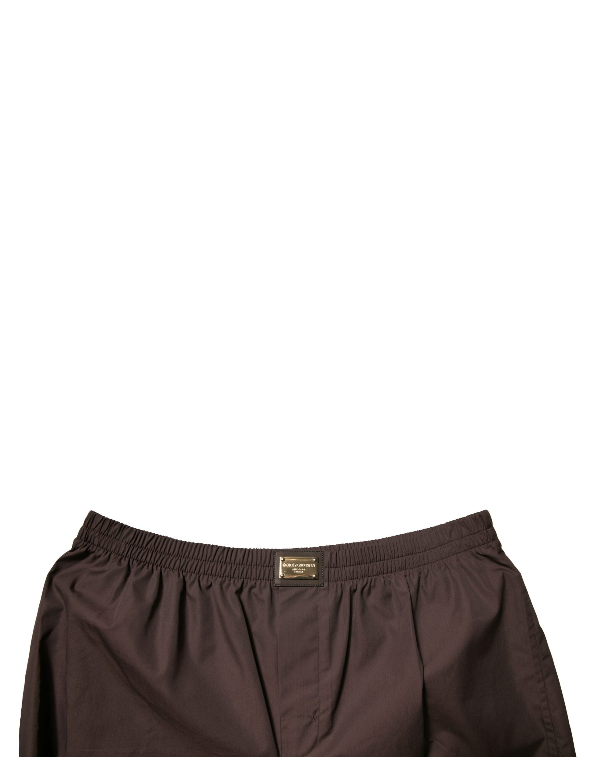 A pair of brown cotton blend men's mid waist shorts with a label on the front