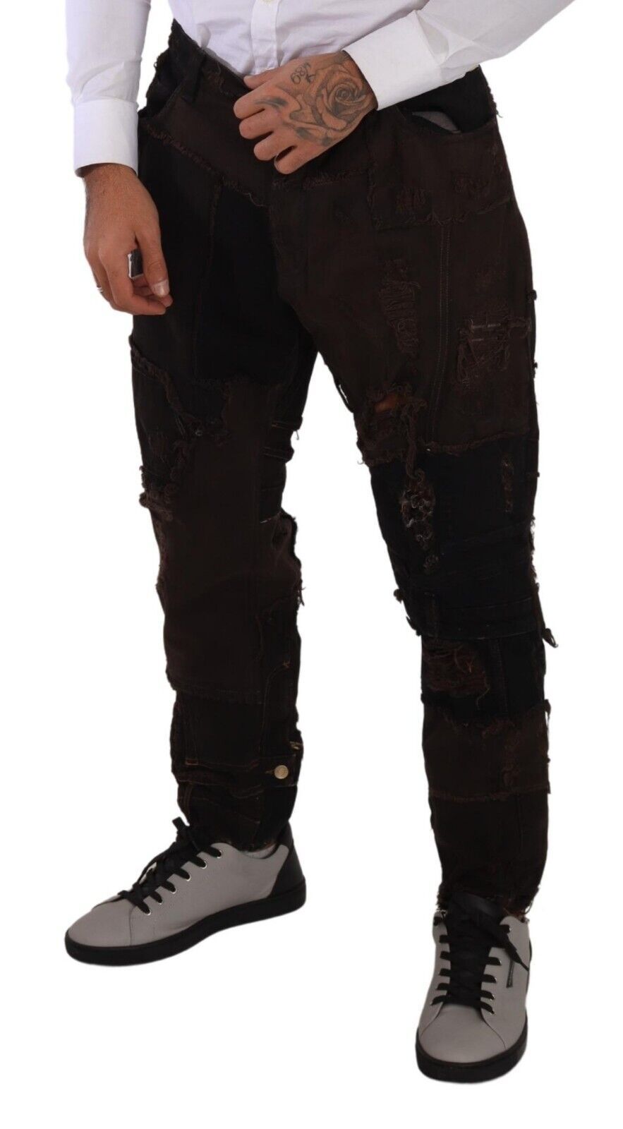 Man wearing ripped jeans and sneakers