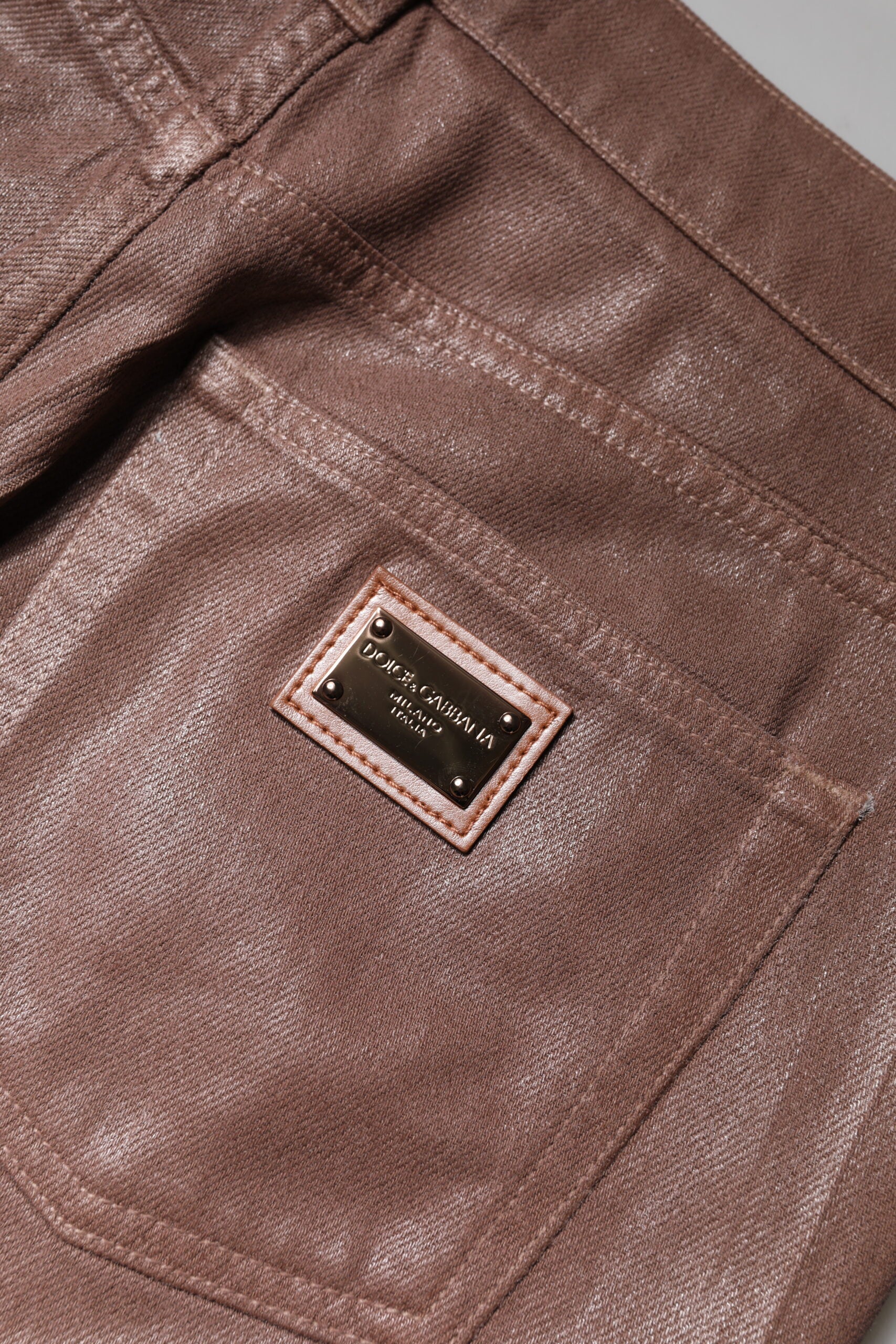 Brown leather pants with a label on the back pocket