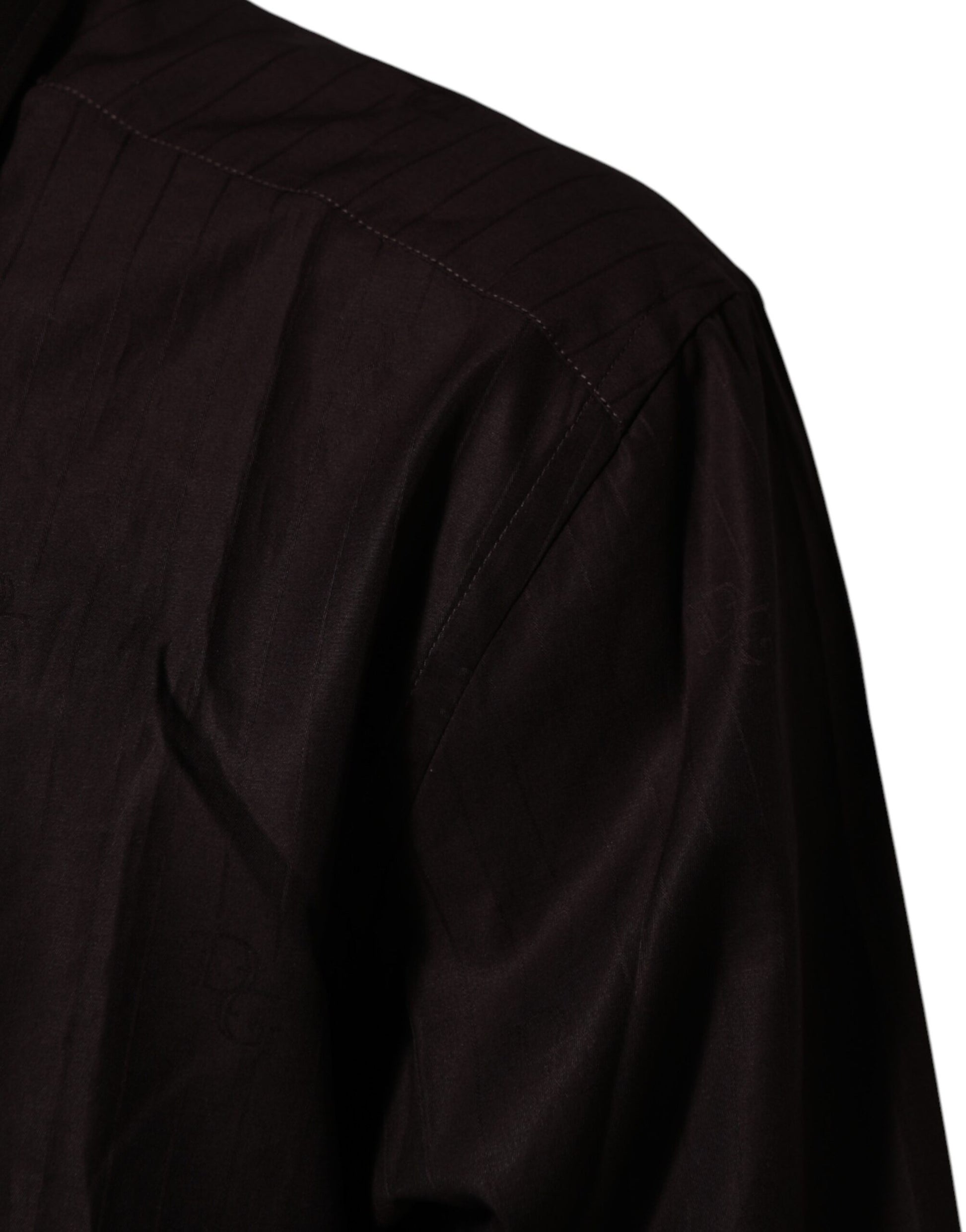 A close-up of a long sleeved dress shirt. It features a brown cotton fabric with a textured pattern and is de
