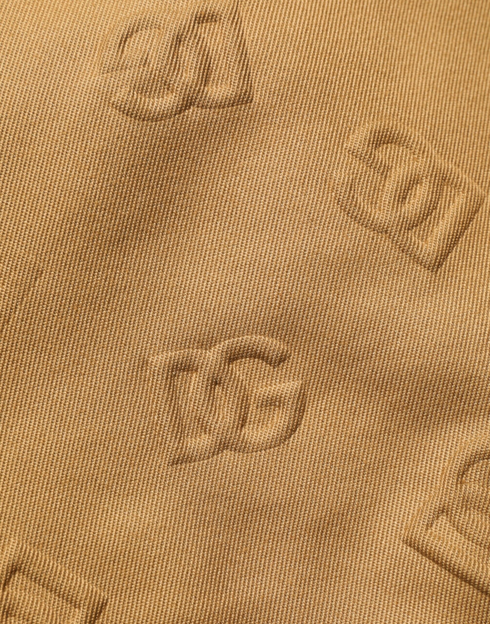 Gold fabric with embroidered letters