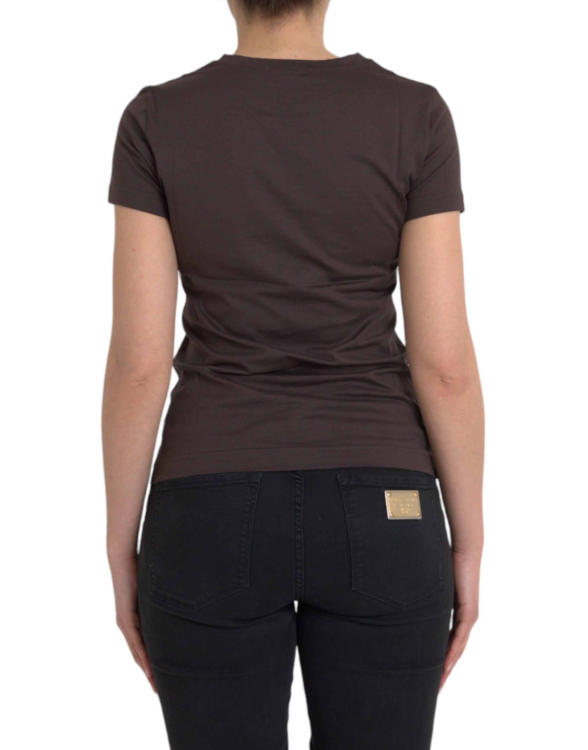 Woman wearing brown shirt and black jeans