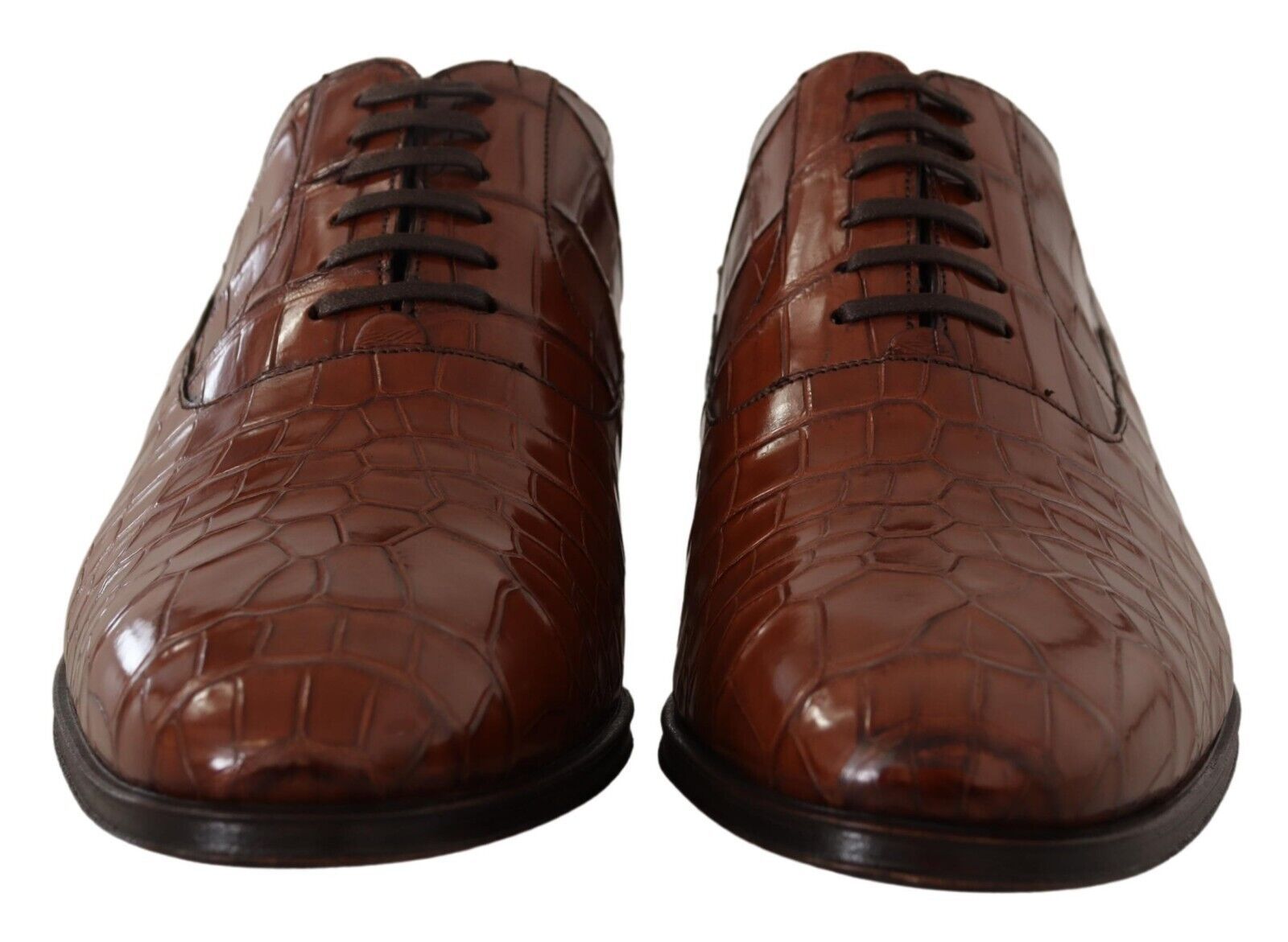 Pair of brown leather shoes with laces and a shiny finish