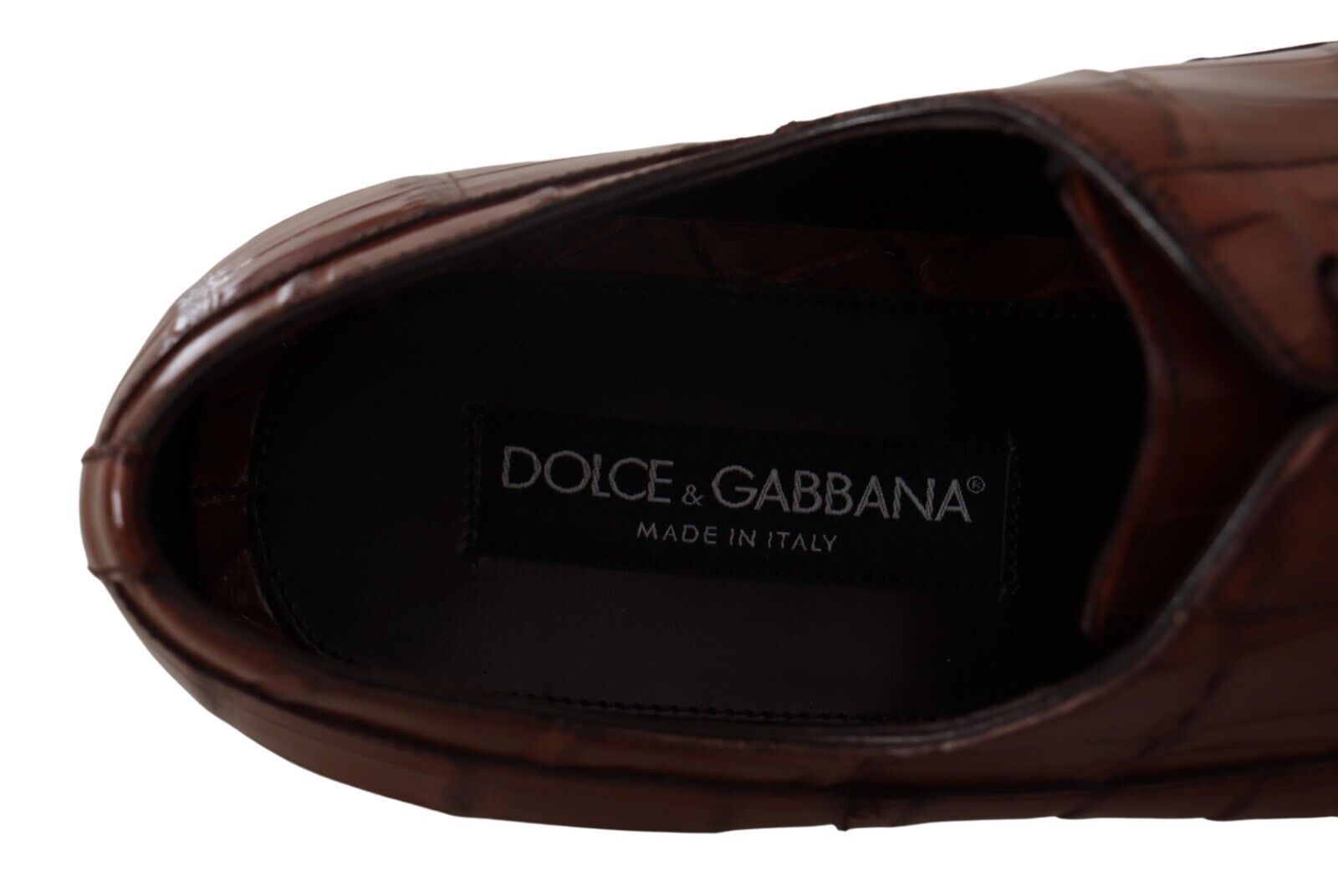 Brown leather shoe with visible logo on insole