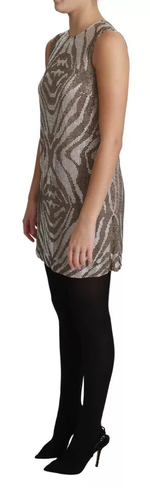 A woman wearing a brown dress with crystals and a zebra print