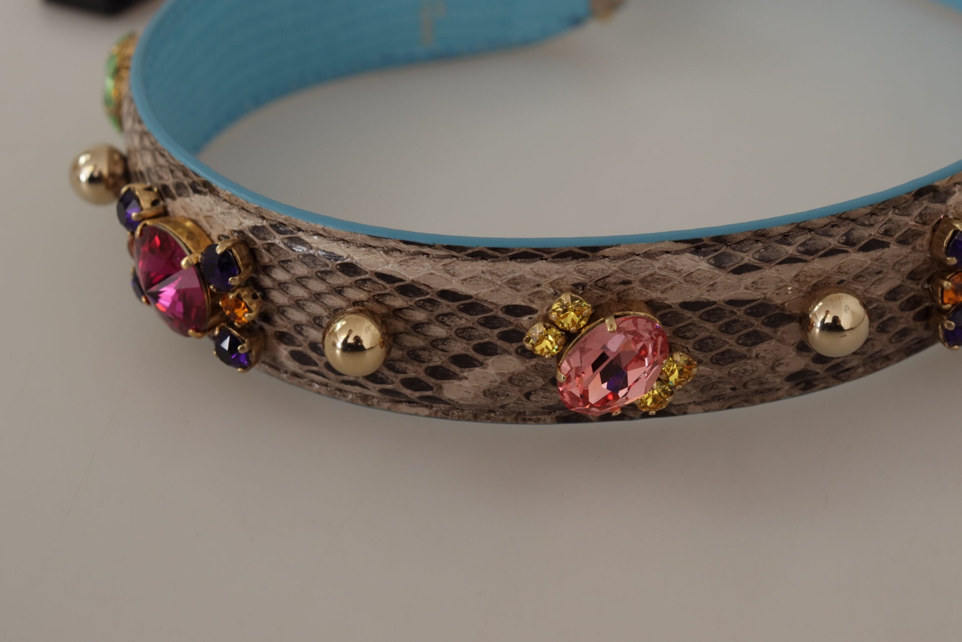 Decorative snake skin bracelet with gold beads and gemstones
