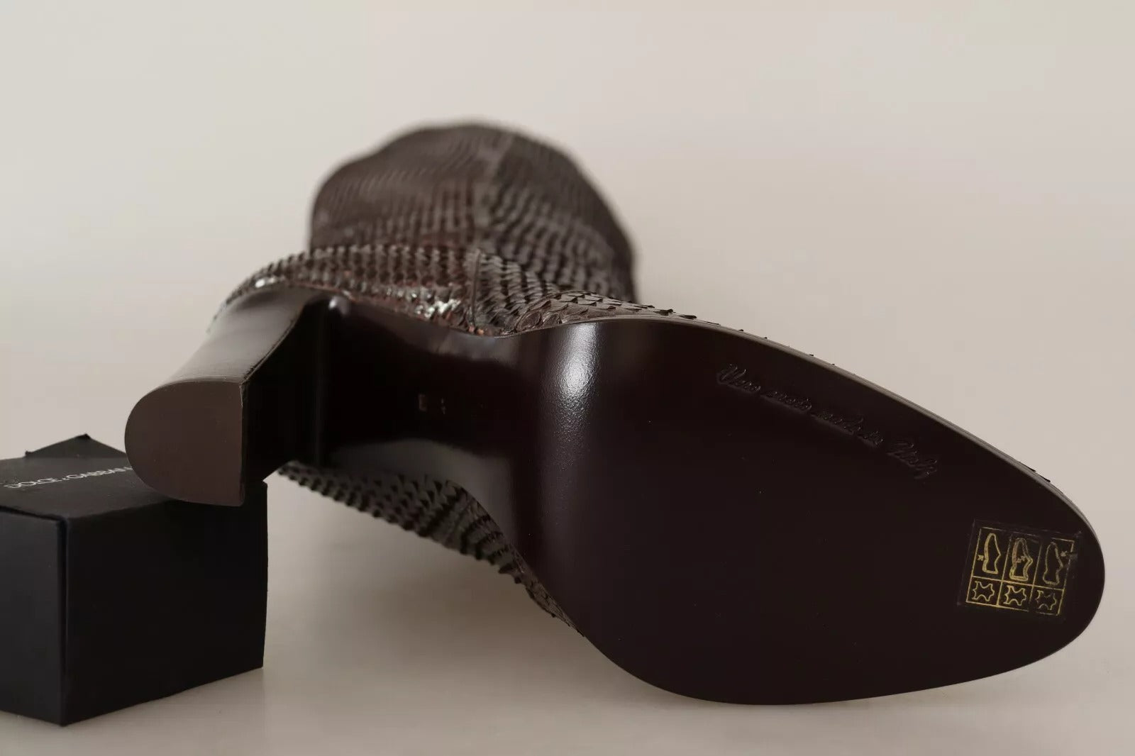 A pair of black shoes with a distinctive design on the side