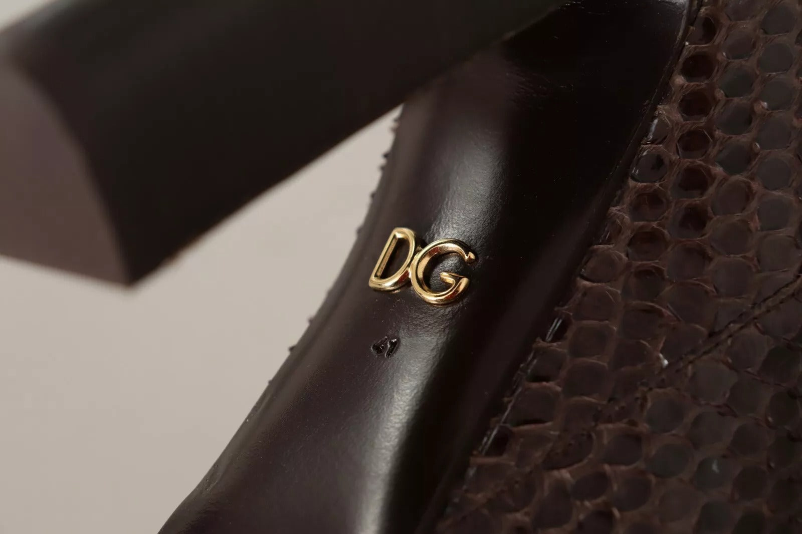 A shoe with a gold DG logo on the side