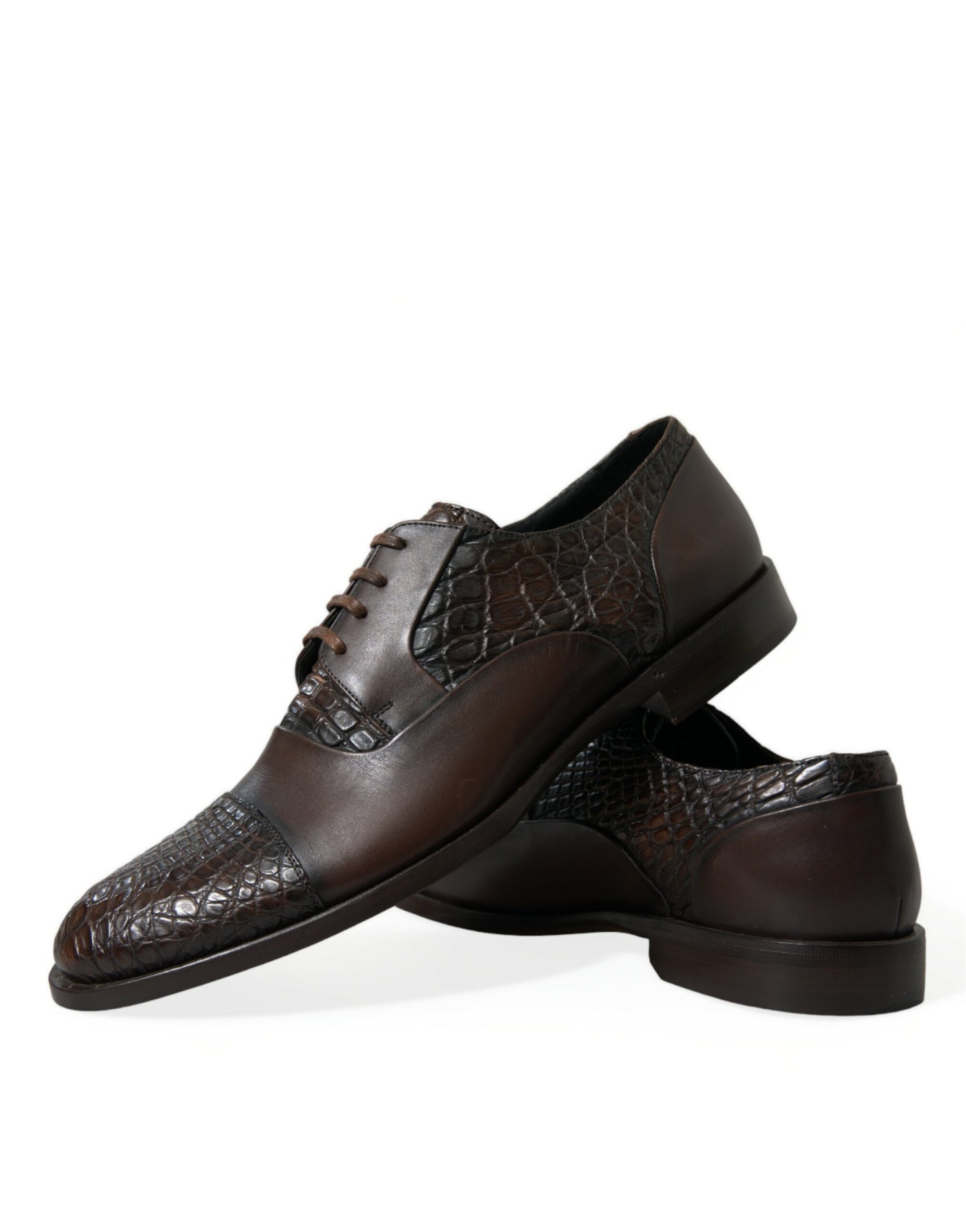 Pair of brown leather shoes with laces and a patterned design on the vamp