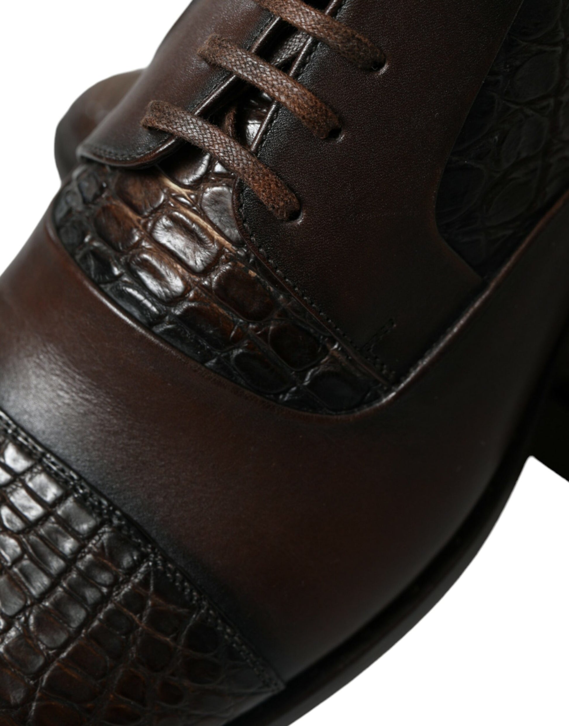 Brown leather shoe with laces and a crocodile skin pattern on the vamp