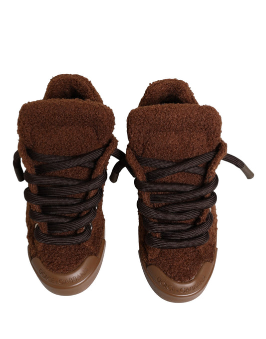 Pair of brown faux shearling sneakers with laces and a low top