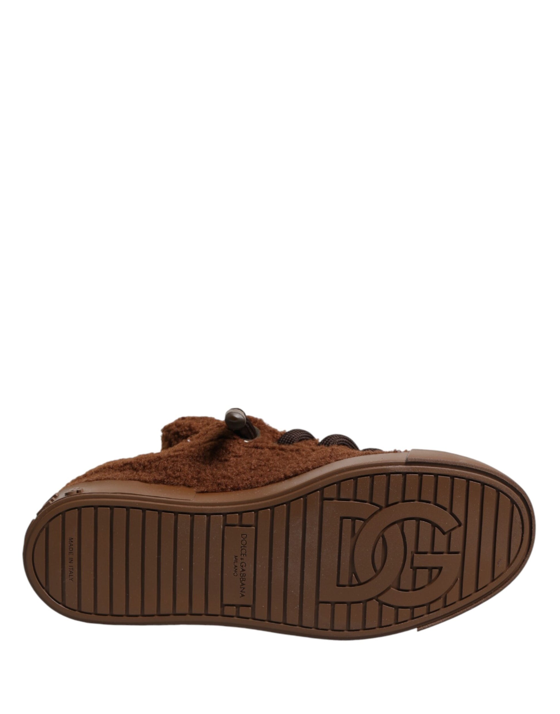 A pair of brown faux shearling low top sneakers with a logo on the side