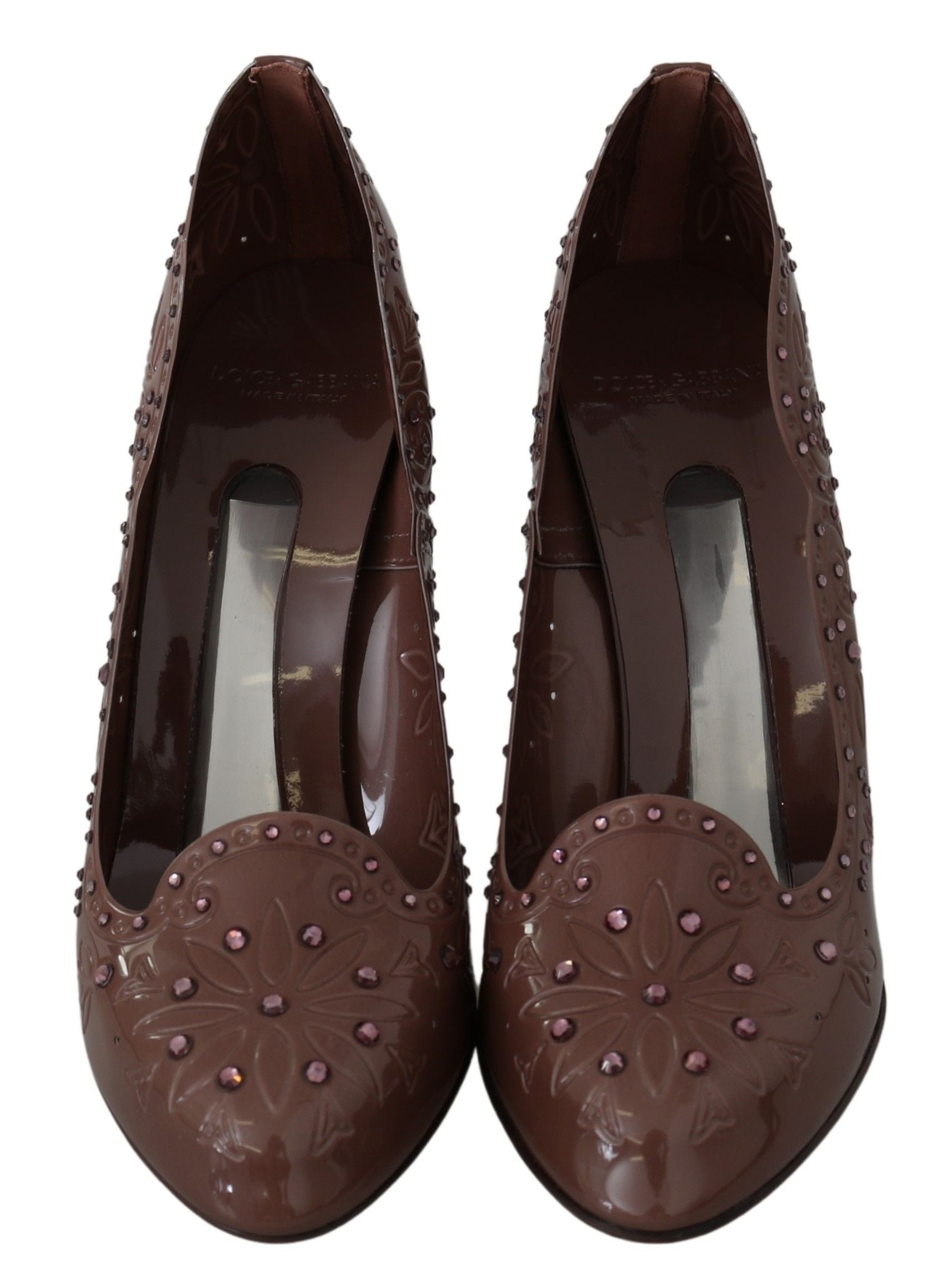 Pair of brown shoes with embellishments and heels
