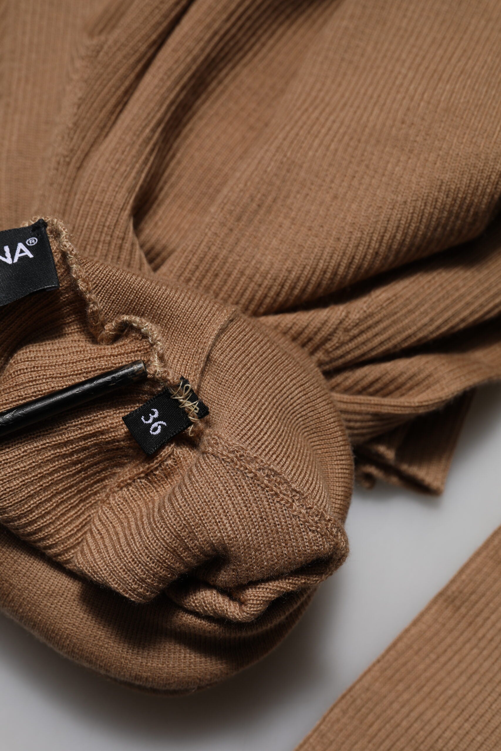 Brown knit sweater on hanger