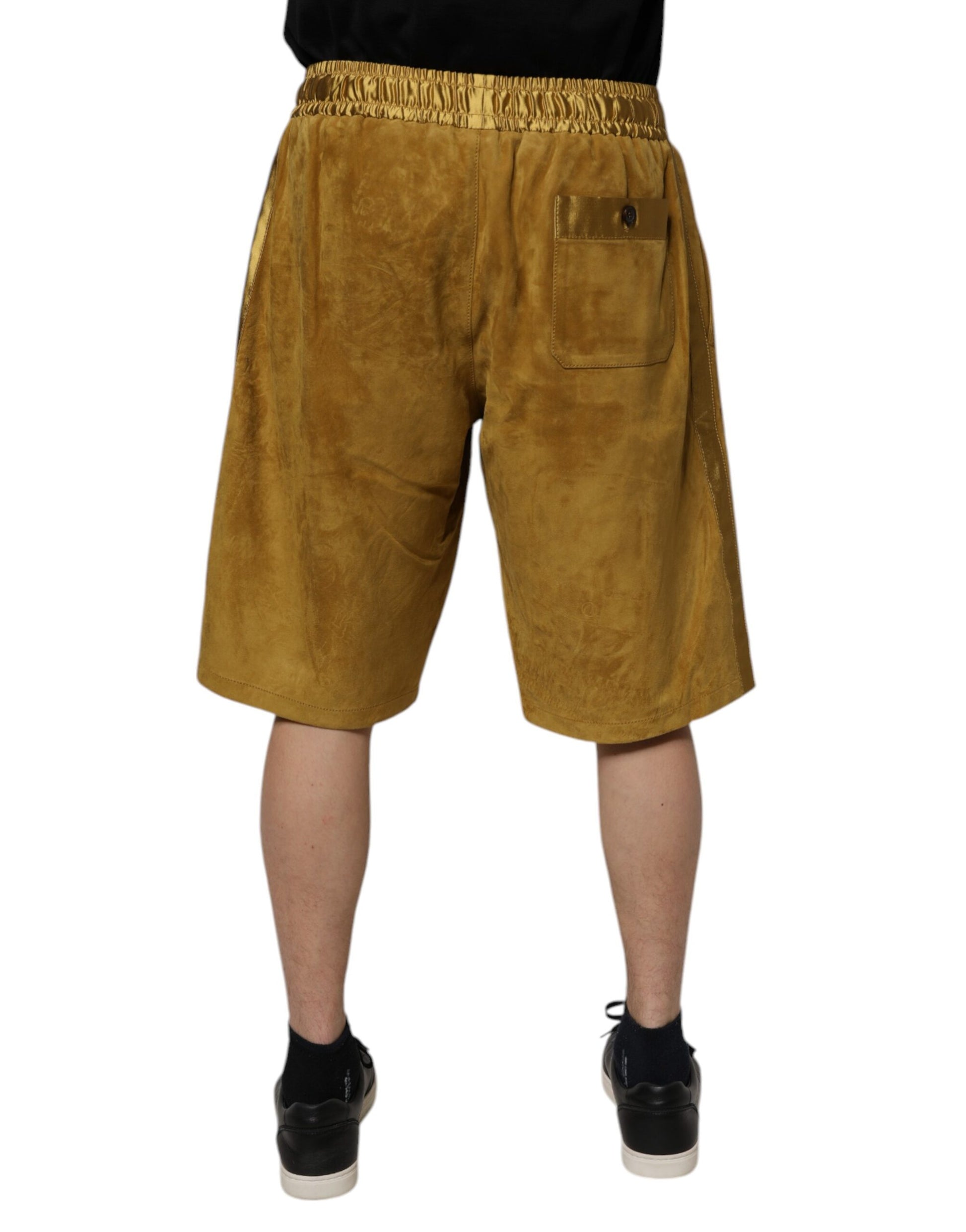 A pair of brown lambskin suede men's bermuda shorts with a pocket on the right leg