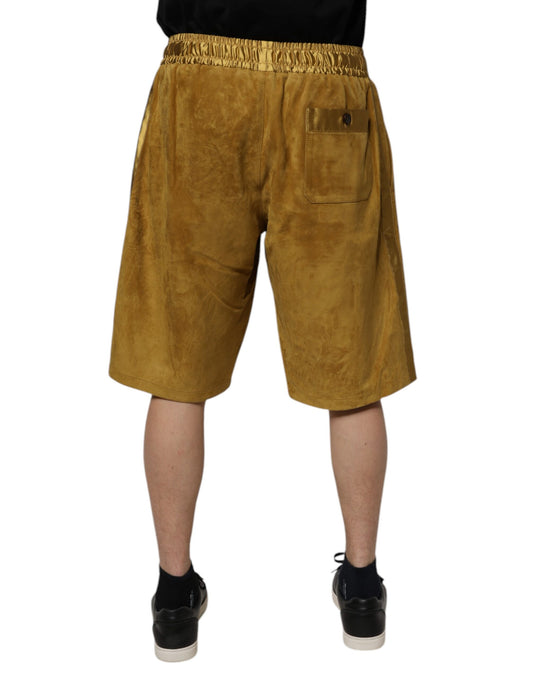 A pair of brown lambskin suede men's bermuda shorts with a pocket on the right leg