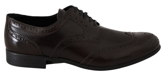 Pair of brown leather shoes with laces and embellishments on soles