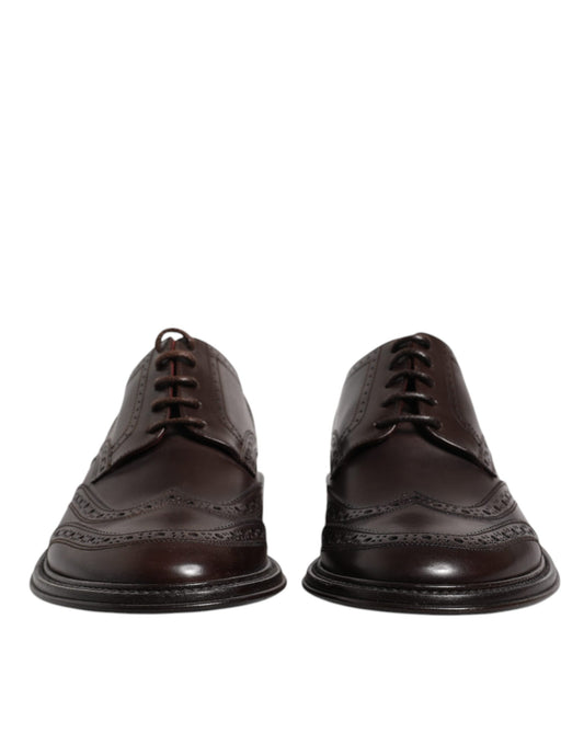 Pair of brown leather lace-up dress shoes with wingtip design