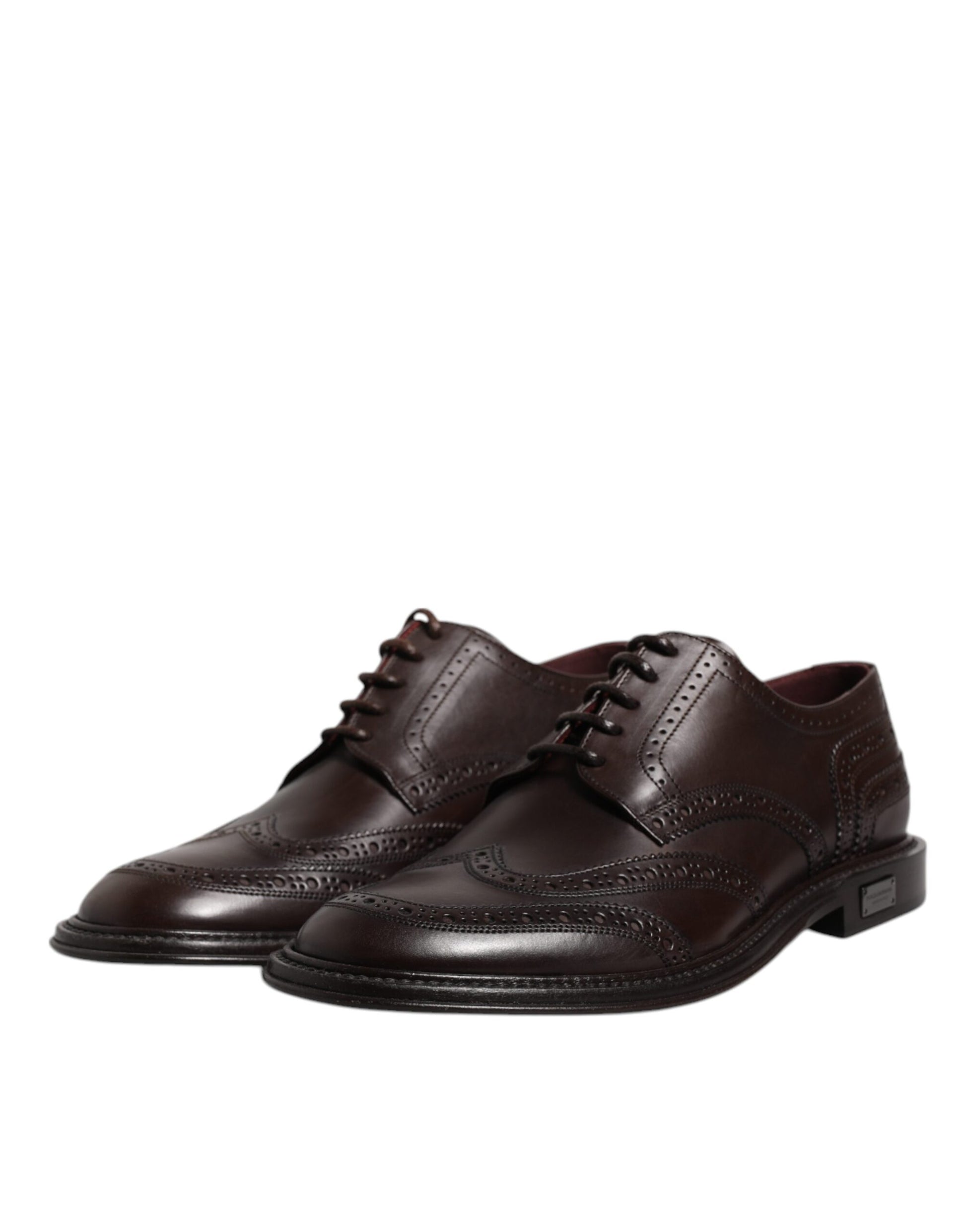 Pair of brown leather dress shoes with laces and wingtip design