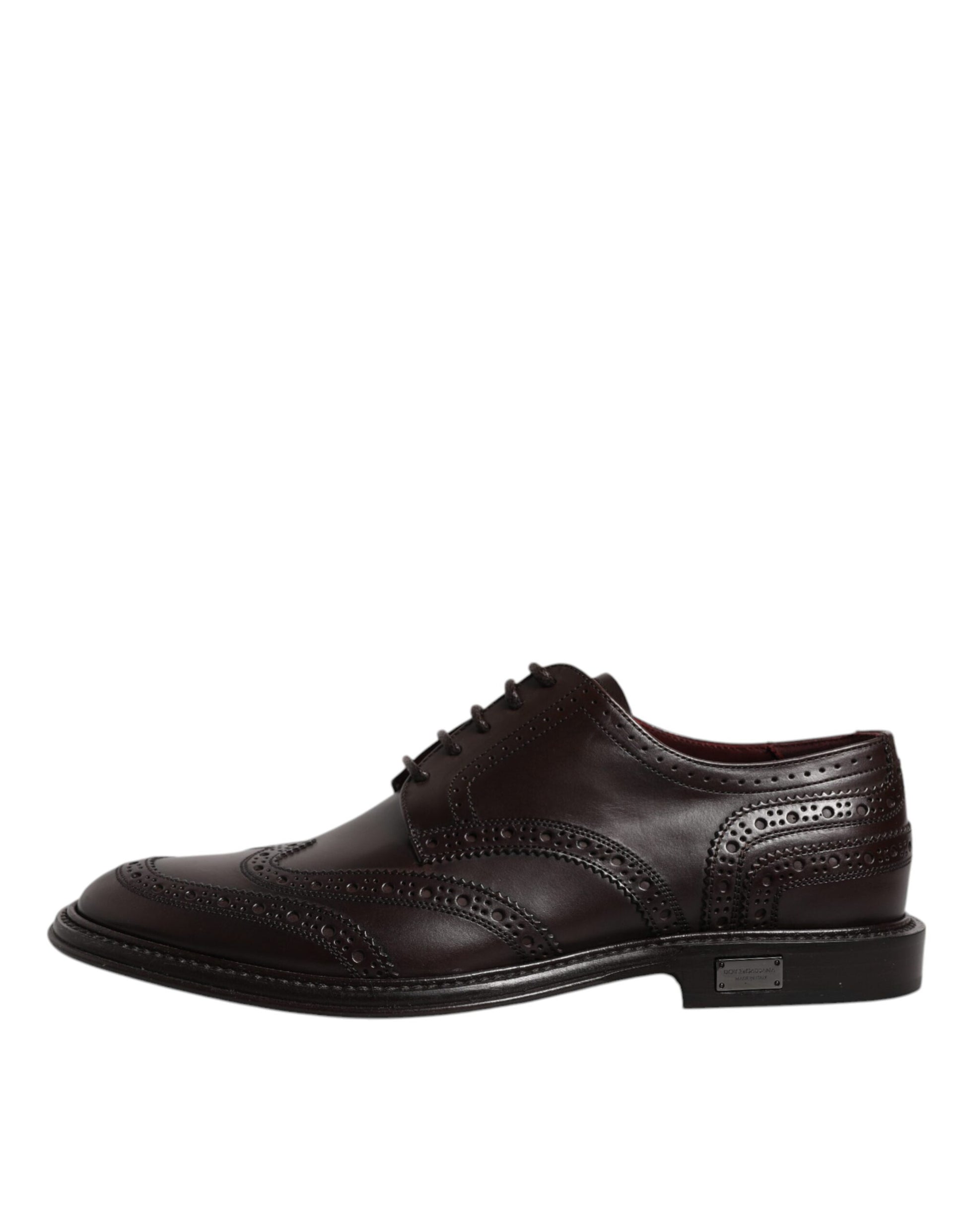Pair of brown leather lace-up dress shoes with wingtip design