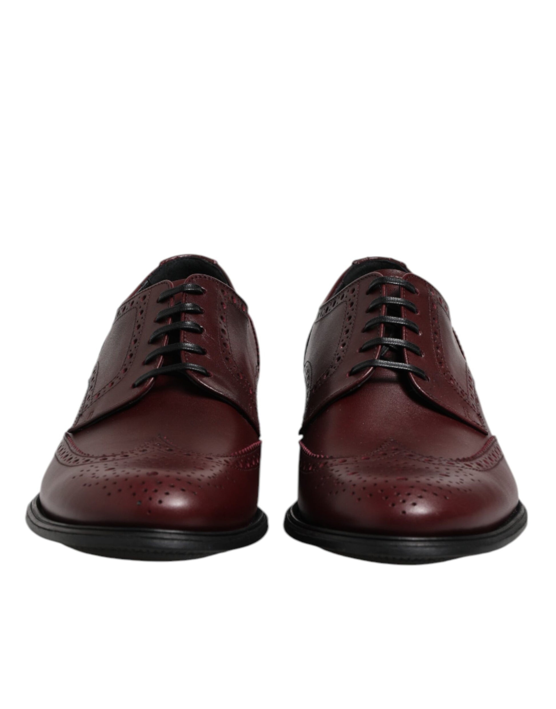 Pair of brown leather lace-up dress shoes with black laces and soles